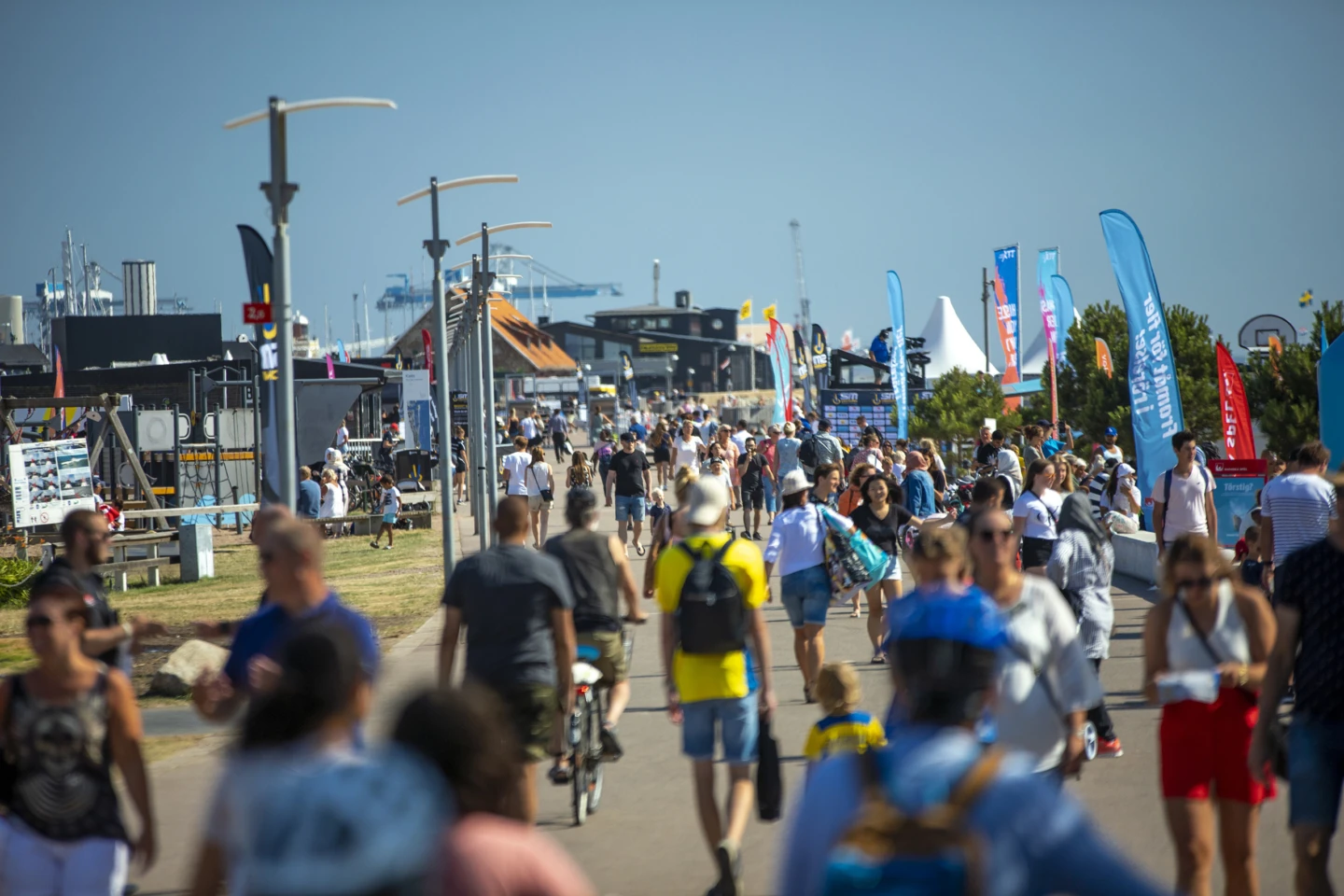 Sommarklädda människor på strandpromenaden i Helsingborg.