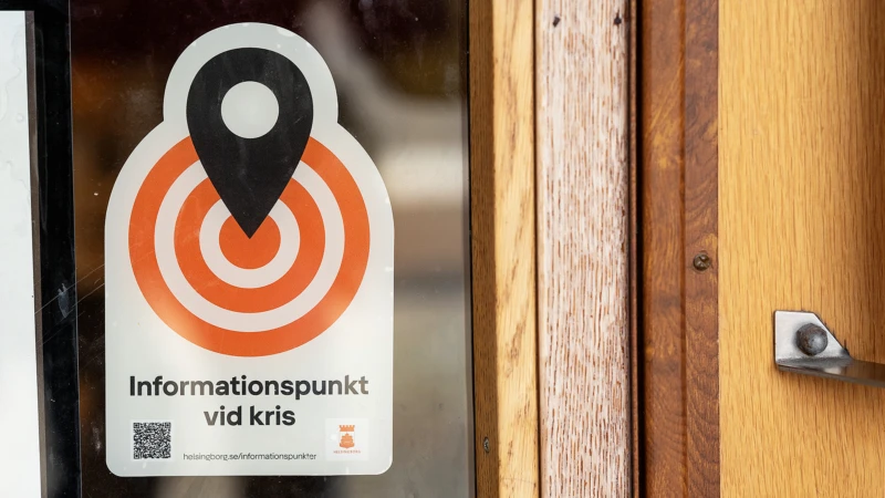 En dekal med texten "Informationspunkt vid kris" sitter på en ytterdörr