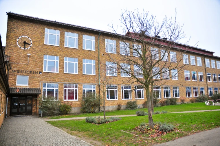 Bild på skolans fasad med en entré. Vy från skolgården.