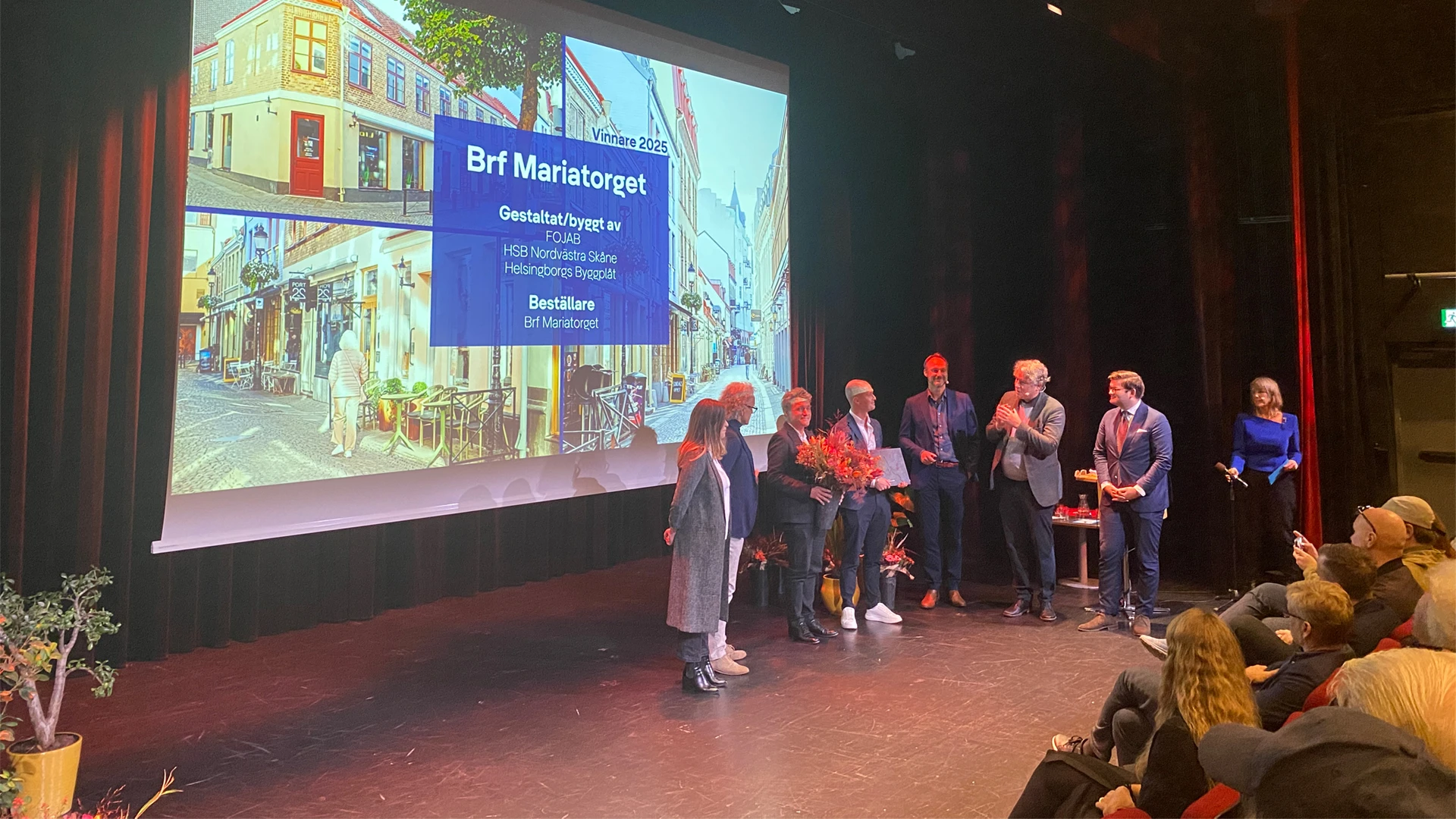 Representanter från FOJAB och HSB Nordvästra Skåne tar emot stadsbyggnadspriset på scen på Dunkers kulturhus.