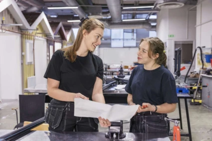 VVS-arbetare visar ritning för praoelev.