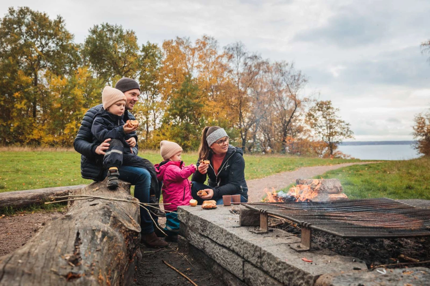 familj som grillar på en grillplats i en skog en höstdag