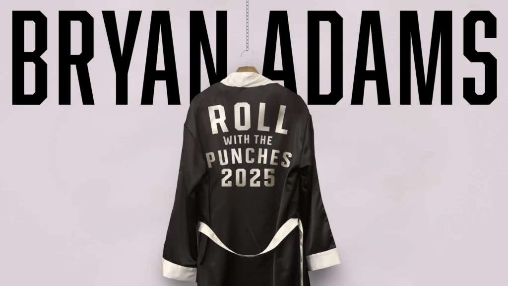 text Bryan Adams, ovanför hänger en svart rock med text på ryggen.