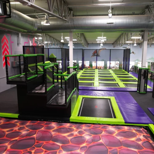 En stor inomhuslekplats med en trampolinpark.