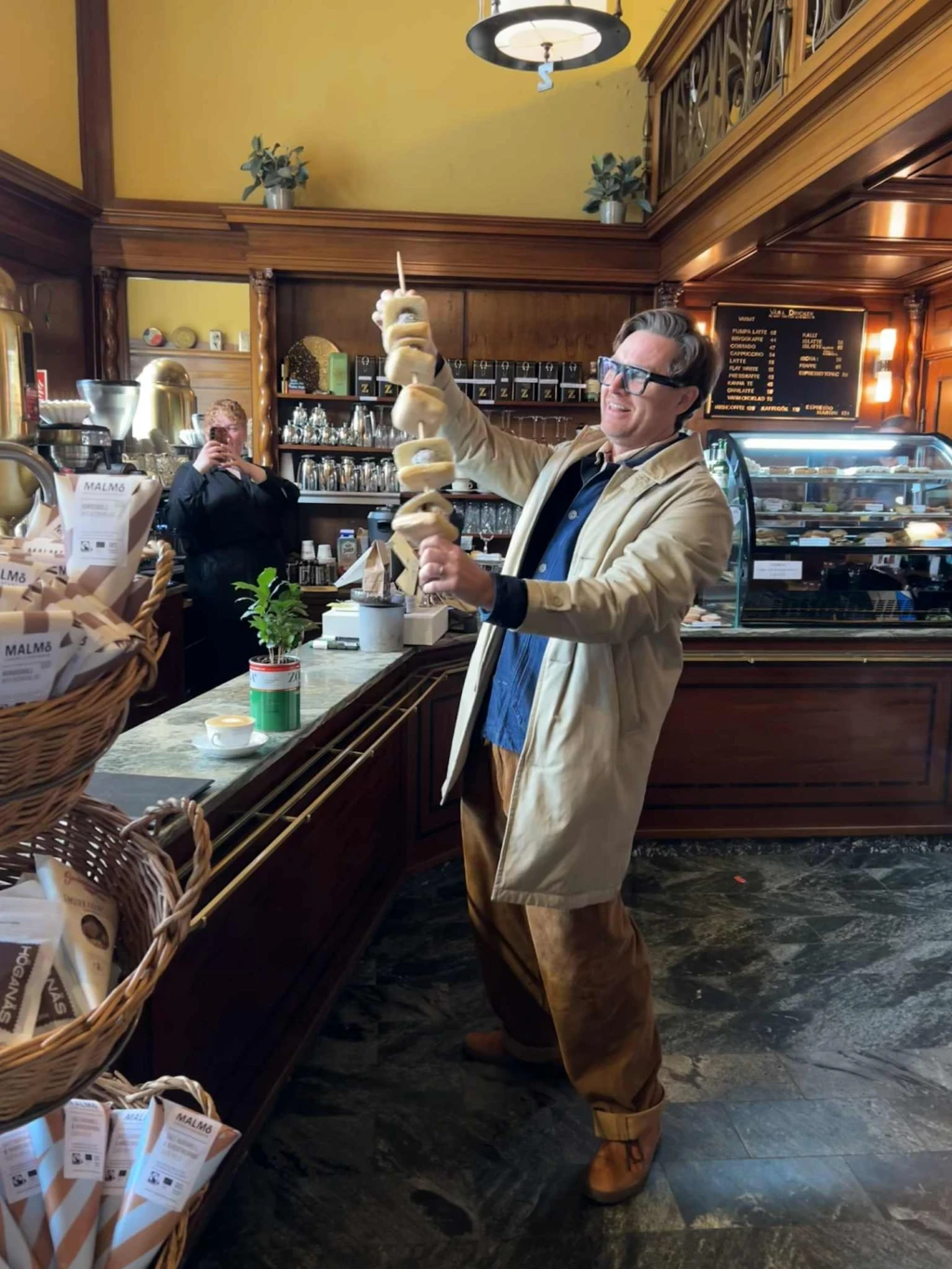 en man med 5 bulle med bulle på ett spett inne på ett cafe