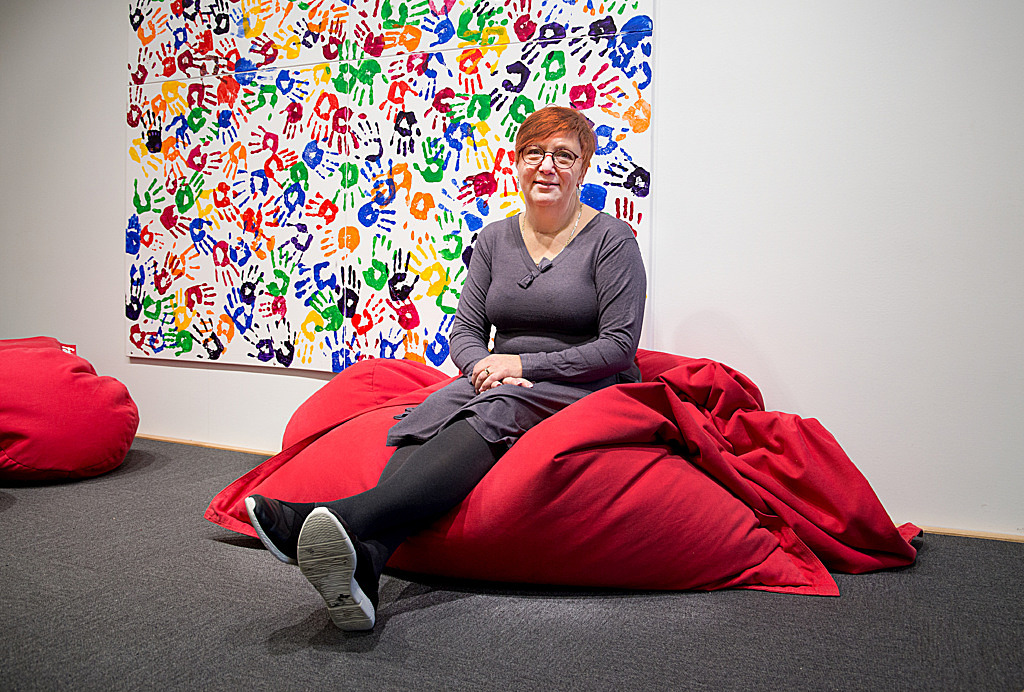 Eva Svensson sitter på en stor kudde i skolmiljö