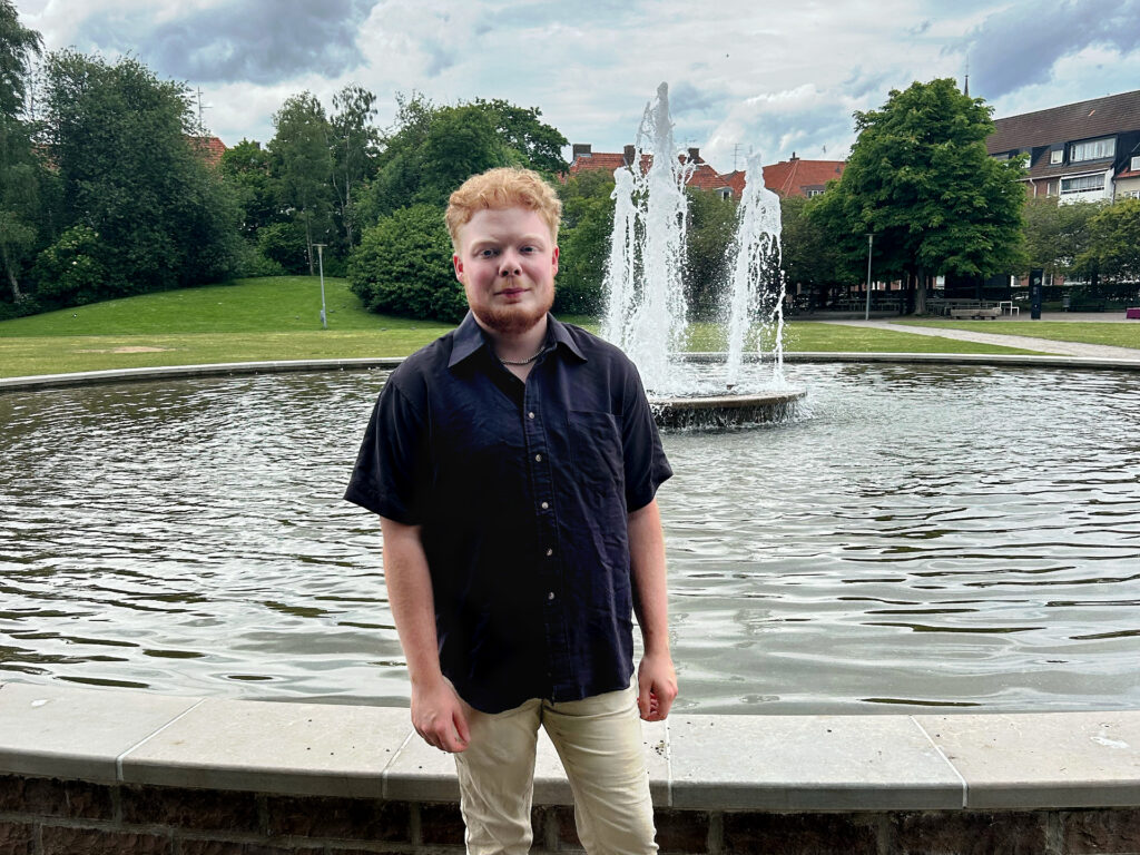 En person står framför en fontän