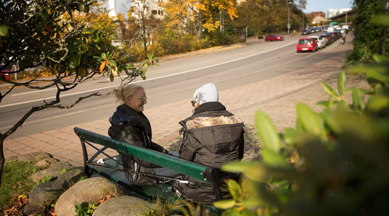 Två kvinnor på bänk, exempel på "elegant soffa" vid gata i Helsingborg.