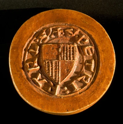 Sigillstamp av brons (avtryck). Påträffad i grav 207 i långhuset i S:t Clemens kyrka. Helsingborgs museums samlingar, foto: Sven Olof Larsén.