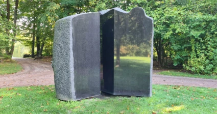 Skulptur i svart, delvis polerad sten.