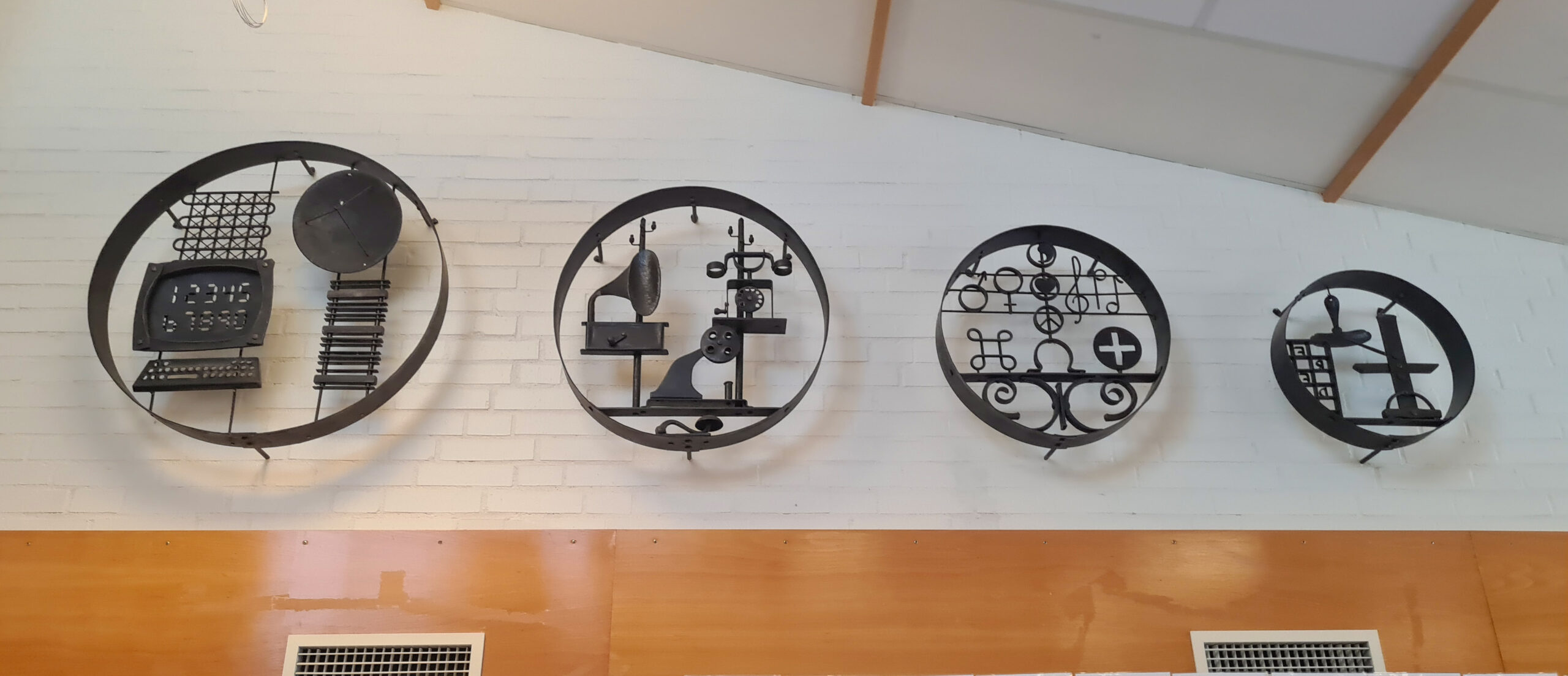 Interiör med smidda runda "tavlor" förställande olika skrifttekniker