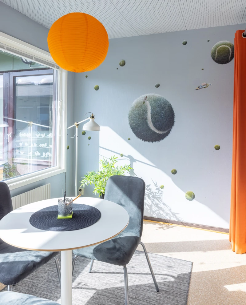 Målningar på vägg med svävande tennisbollar. 