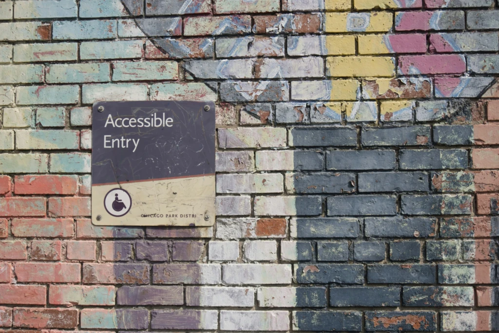 A colorful wall with a sign that says "Accessible Entry."
