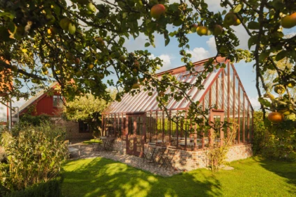 Orangeri i en lummig trädgård